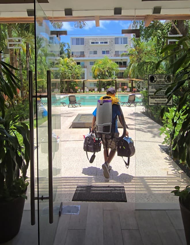 Qtana team member arriving on-site with cleaning equipment