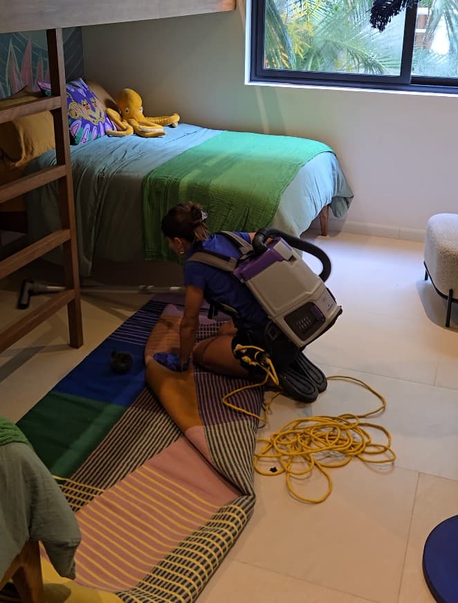 Qtana cleaner using an upholstery extraction tool on fabric
